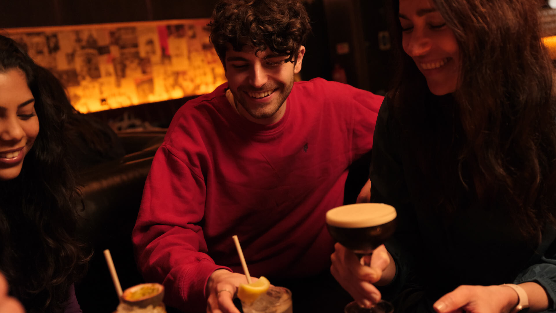 Evening in the City - East Cheap Records - group of three having cocktails in a low lit bar