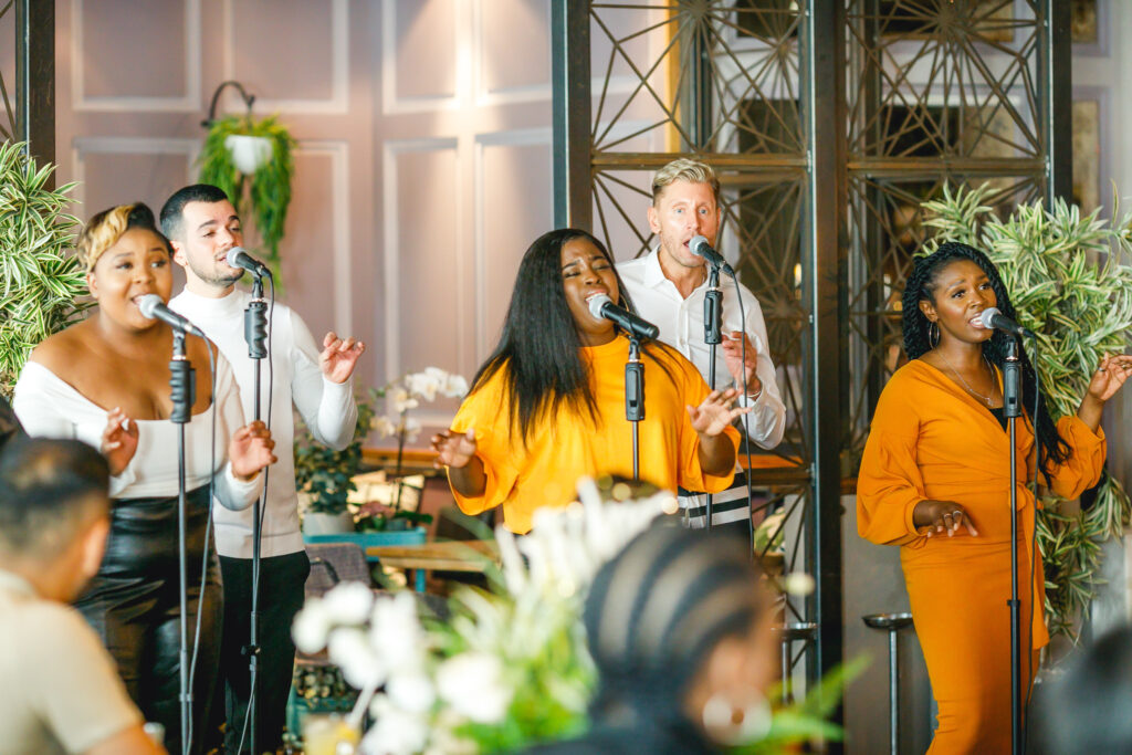 9 Best Brunch Spots in the City of London - Gospel Motown Brunch - a group of gospel singers men and women performing in front of guests