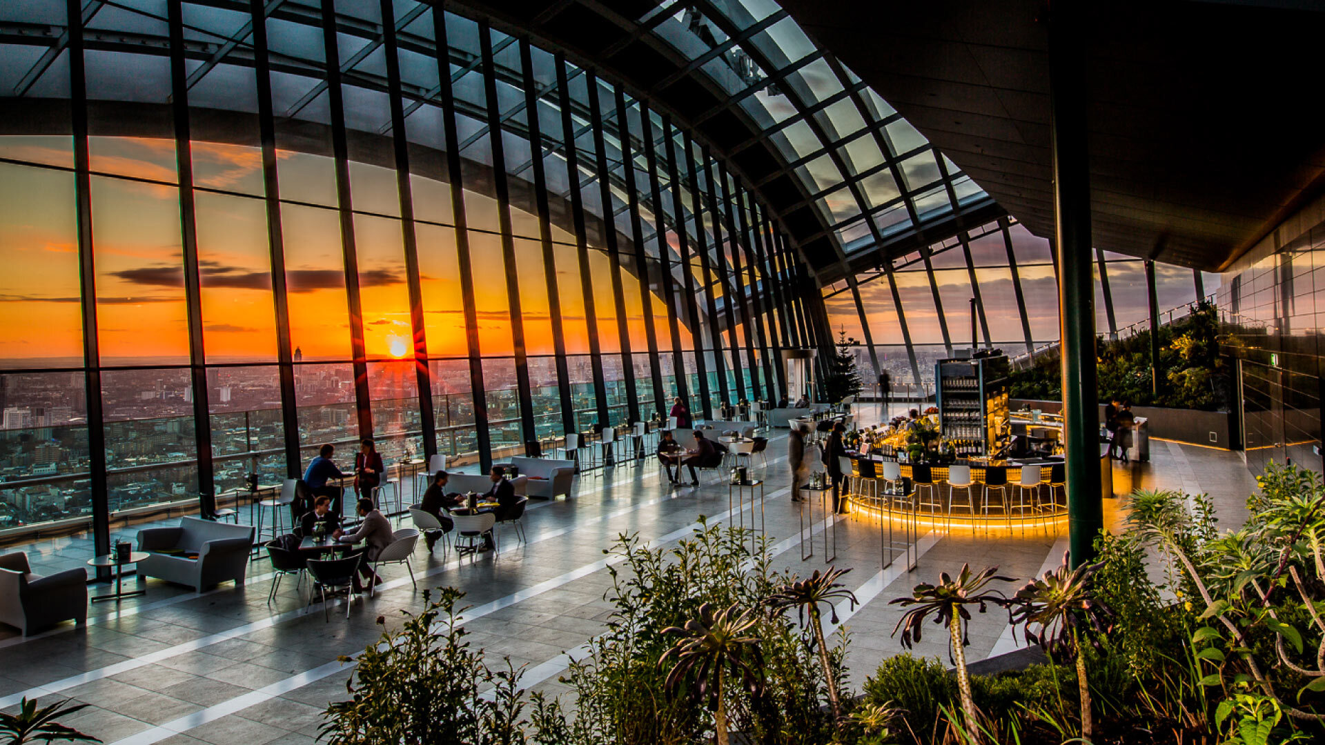 8 best Instagrammable places in London - Rhubarb at Sky Garden - large open space, heigh glass windows with view of the city, planting in the foreground and bar and seating in the background