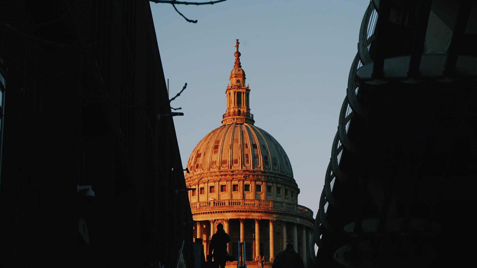 8 best Instagrammable places in London - St Pauls Cathedral - view of St Paul's Cathedral spire, glowing orange in the sun set, blue skies.