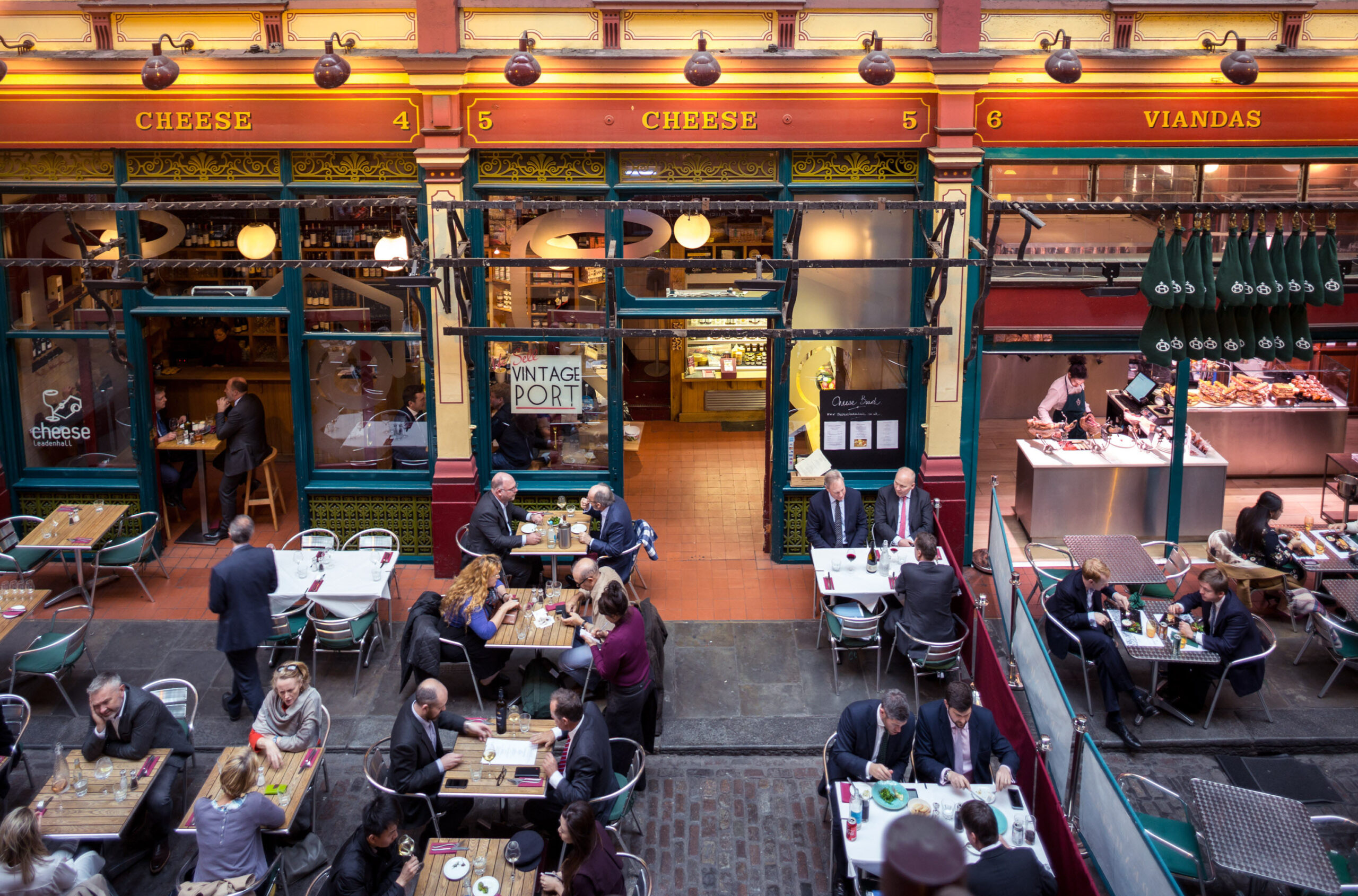 Best Independent Shopping Experiences - Cheese at Leadenhall - people eating at tables in front of the restaurant inside the covered market