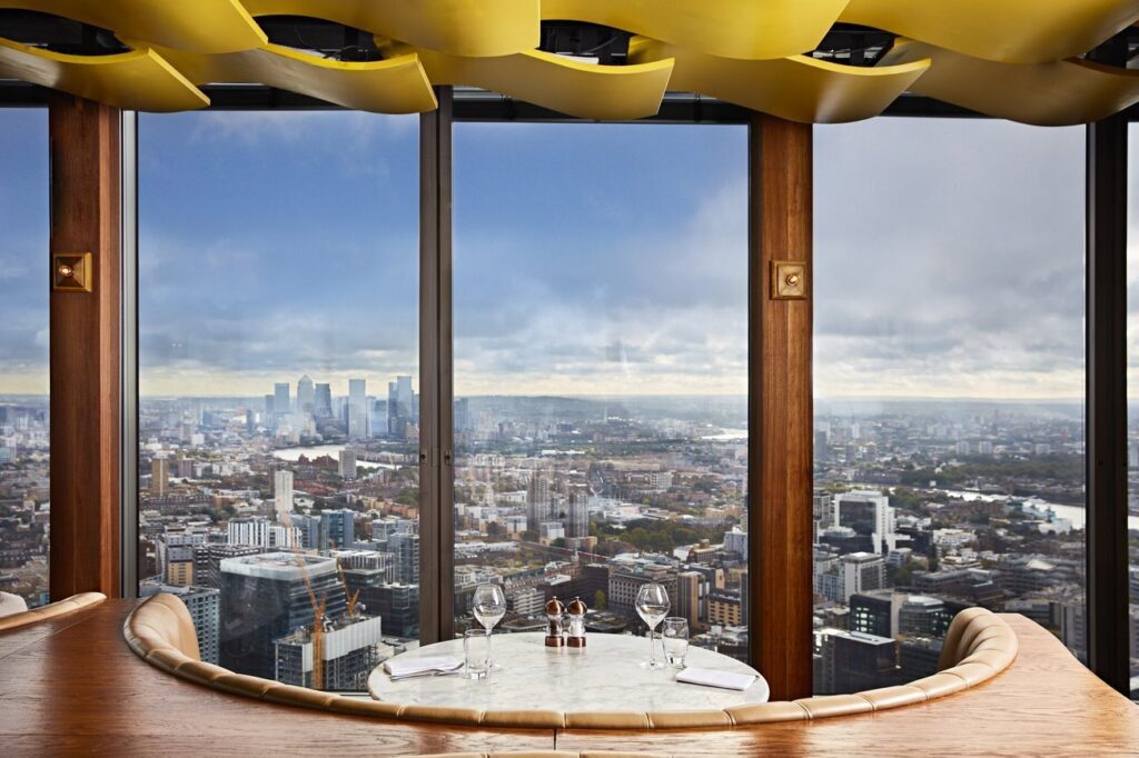 9 Best Brunch Spots in the City of London - Duck and Waffle London - circular table with view of london