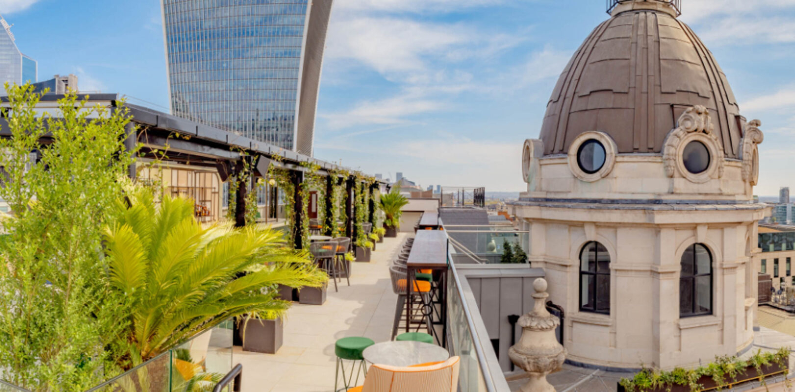 9 Best Brunch Spots in the City of London - Wagtail roof terrace - long balcony terrace with potted plants and blue skies