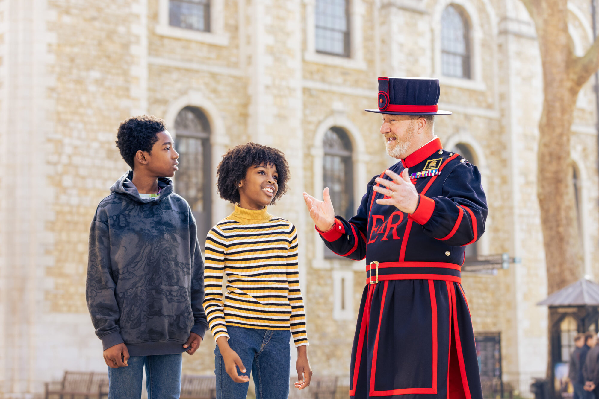 Tower of London - a man wearing Tower of London costume speaks to a group of children