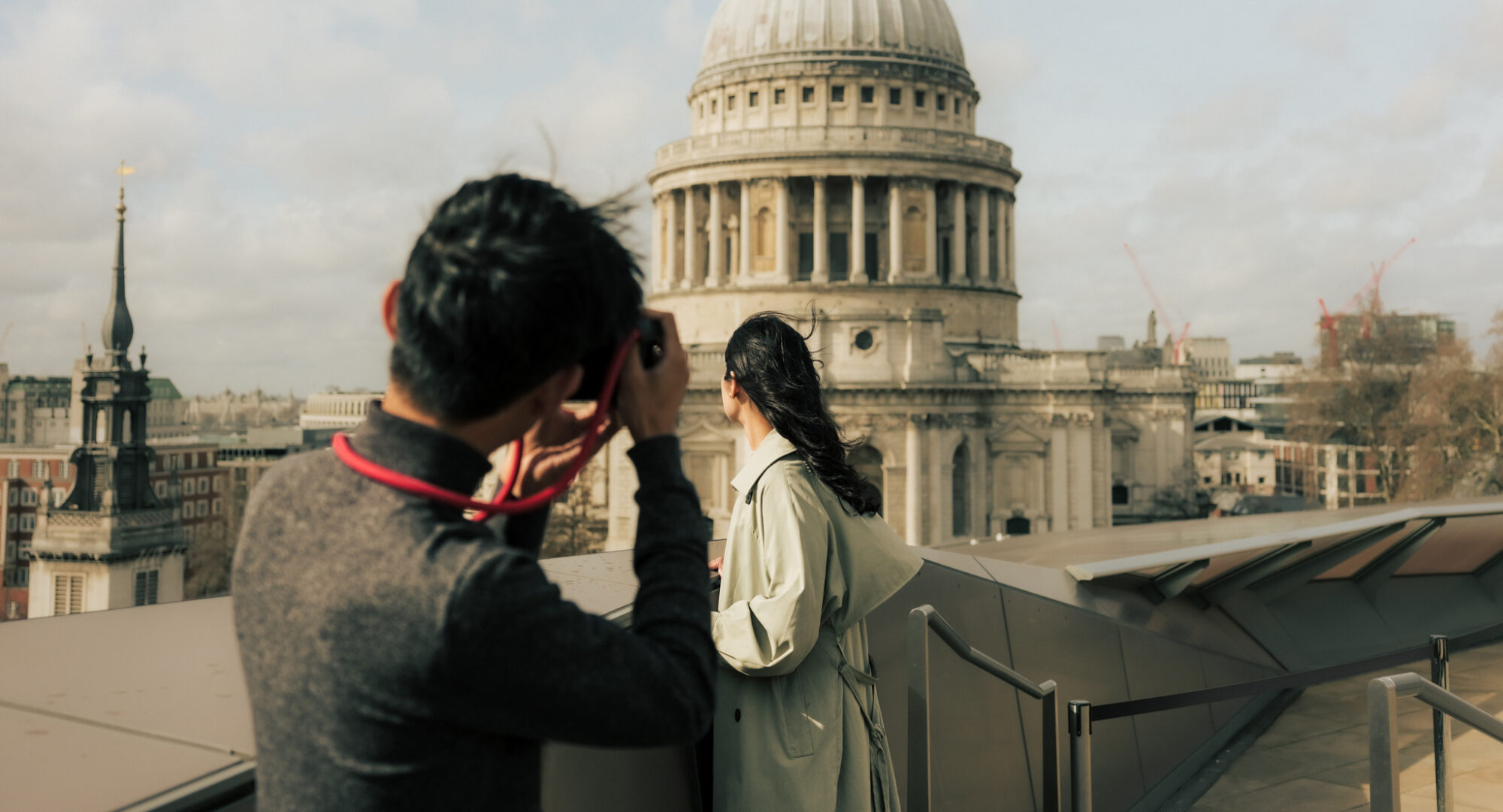 Attractions in the City of London - photoshoot in front of St Paul's - man taking picture of woman with DSLR camera