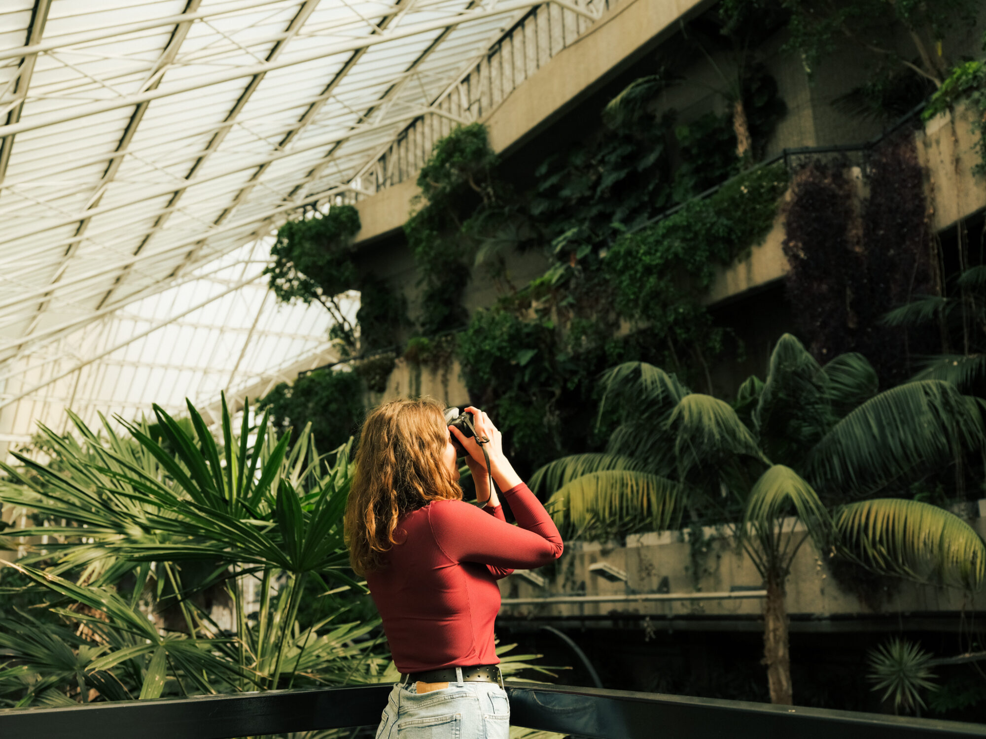 Attractions in the City of London - woman taking a picture in Barbican conservatory