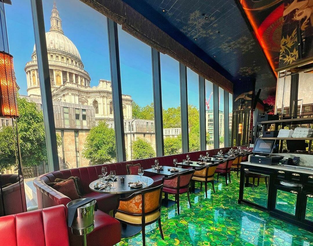 View of St Paul's Cathedral from the glass window of a modern restaurant 
