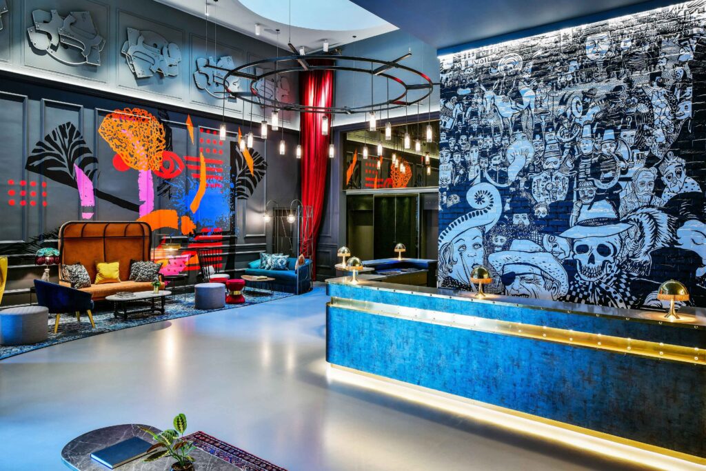 Andaz Lounge - bright blue walls and counter in a colourful lobby