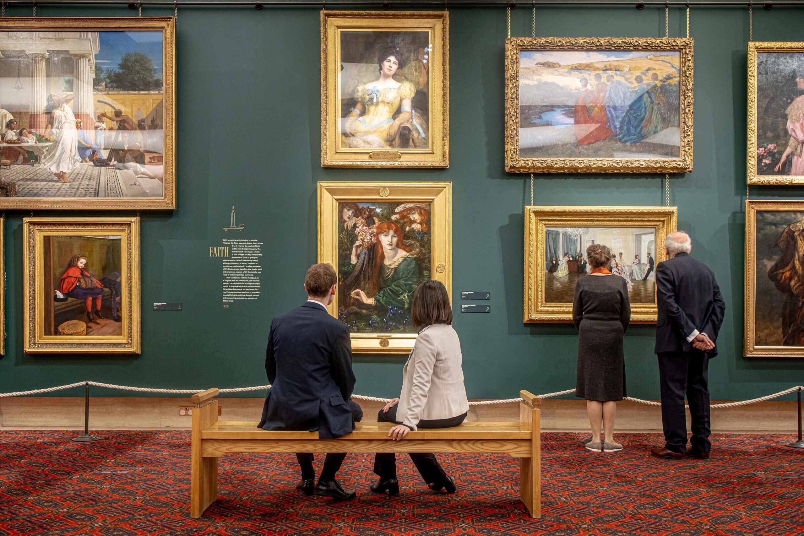 What to do in the City of London - Guildhall Gallery interior - paintings hanging on a wall with smart people viewing from a bench