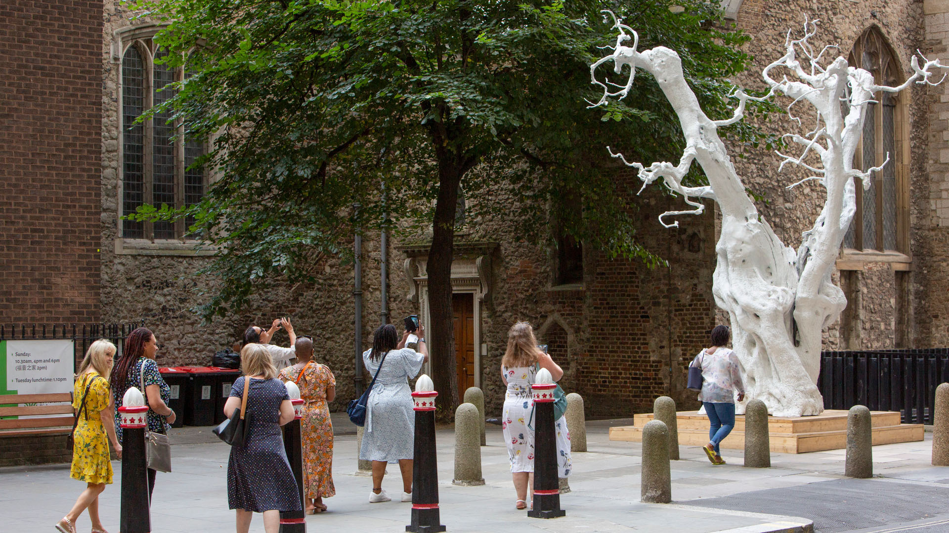 Life-size sculpture of an ancient olive tree in white-painted aluminium.