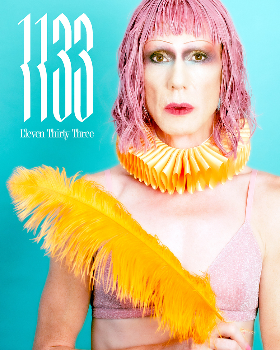 Poster of a person wearing a pink wig and carrying a golden feather on a blue background with the date 1133 on the top left corner
