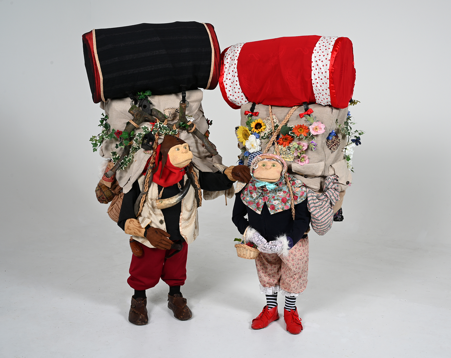 Dressed up characters carrying big backpacks 