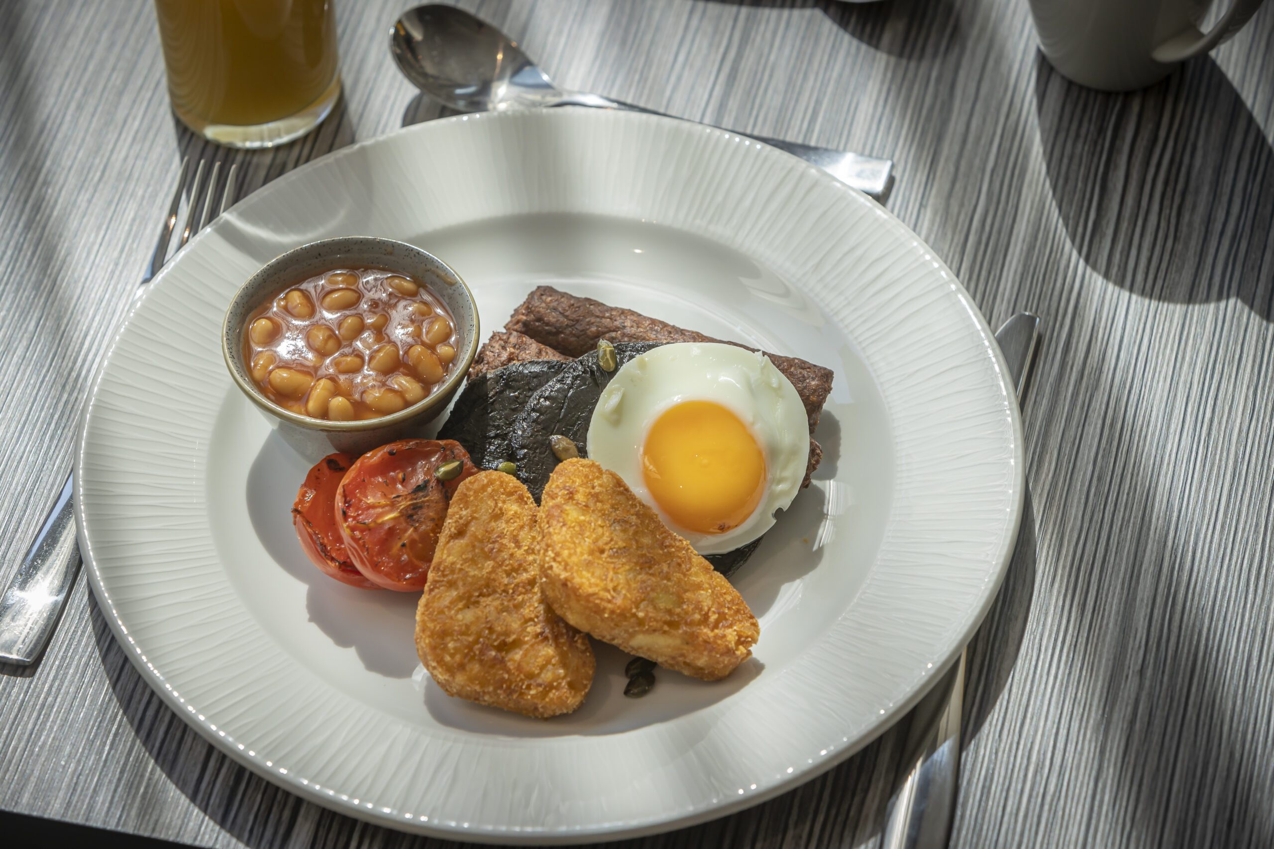 fried egg, tomato, mushroom, beans, sausages and hash brown