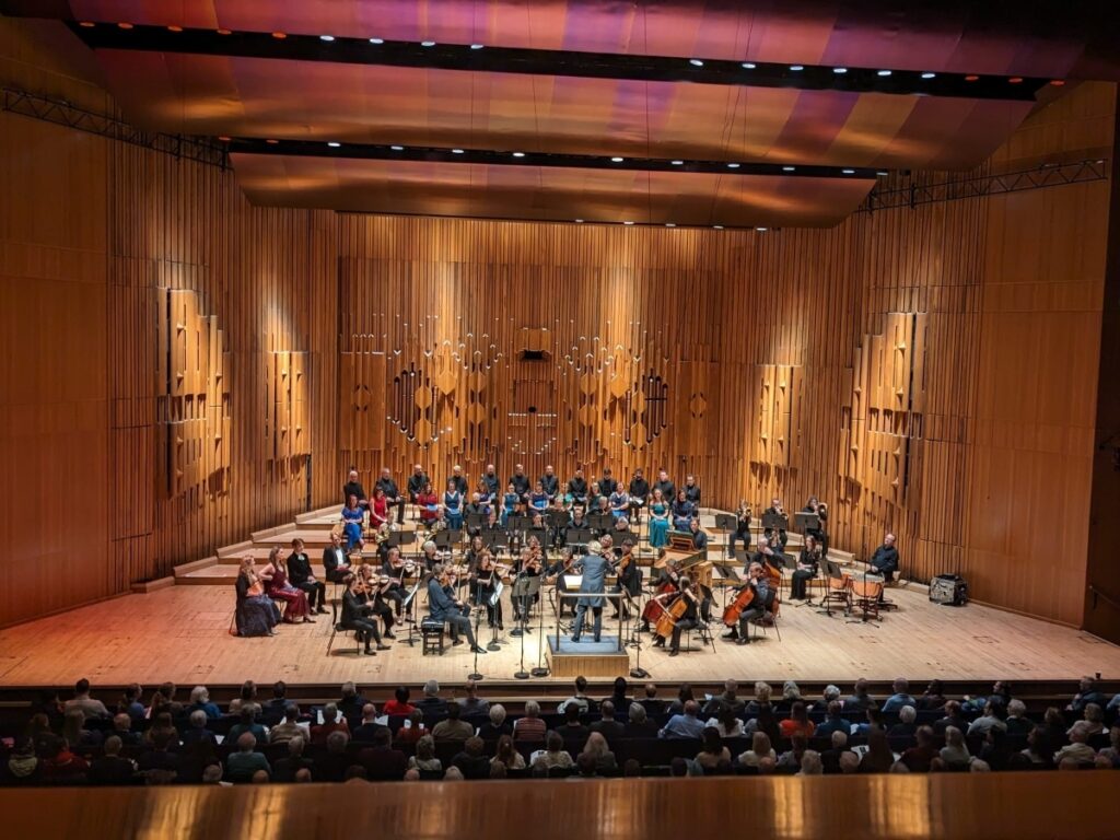 Concert - the London Symphony Orchestra on stage, with a conductor standing in front.