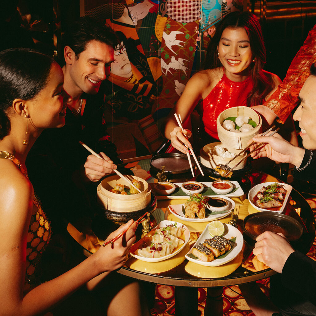 A group of people enjoying a meal at The Ivy Asia.