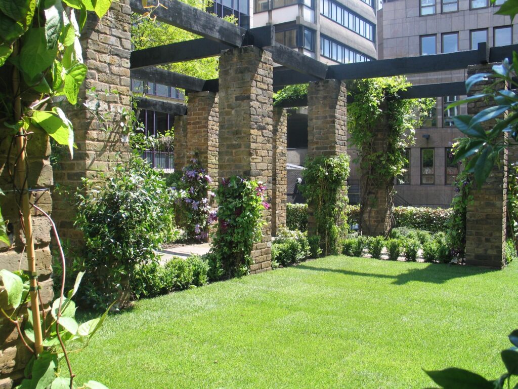 Cleary Garden in the City of London with wooden arbours and a green lawn.