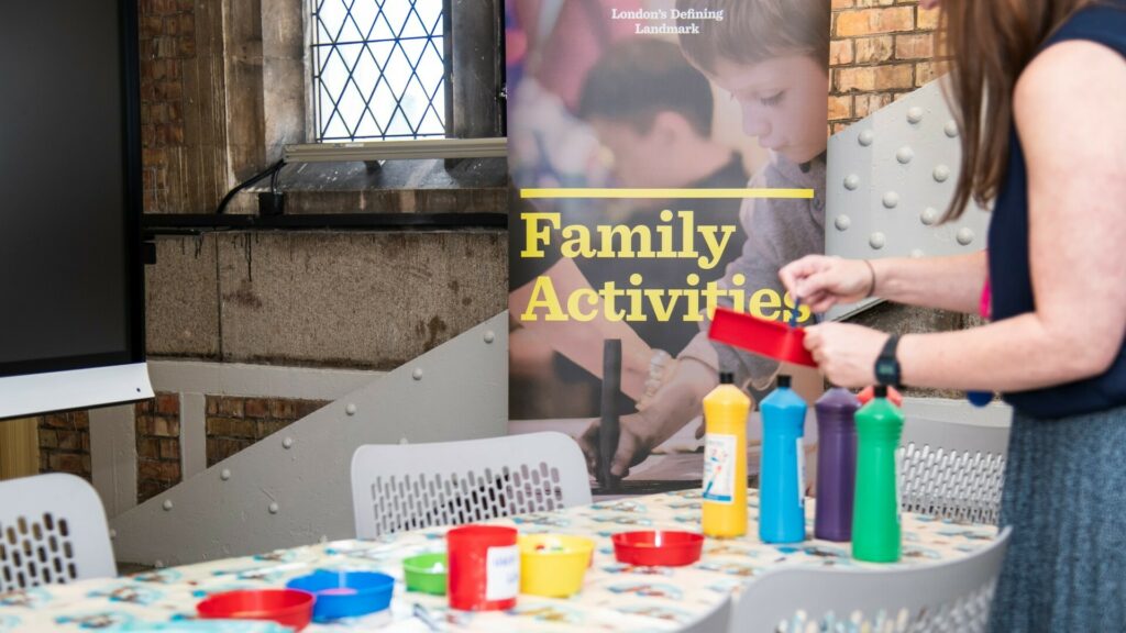 Brightly coloured paints on a table, and a pop-up banner saying "Family Activities".