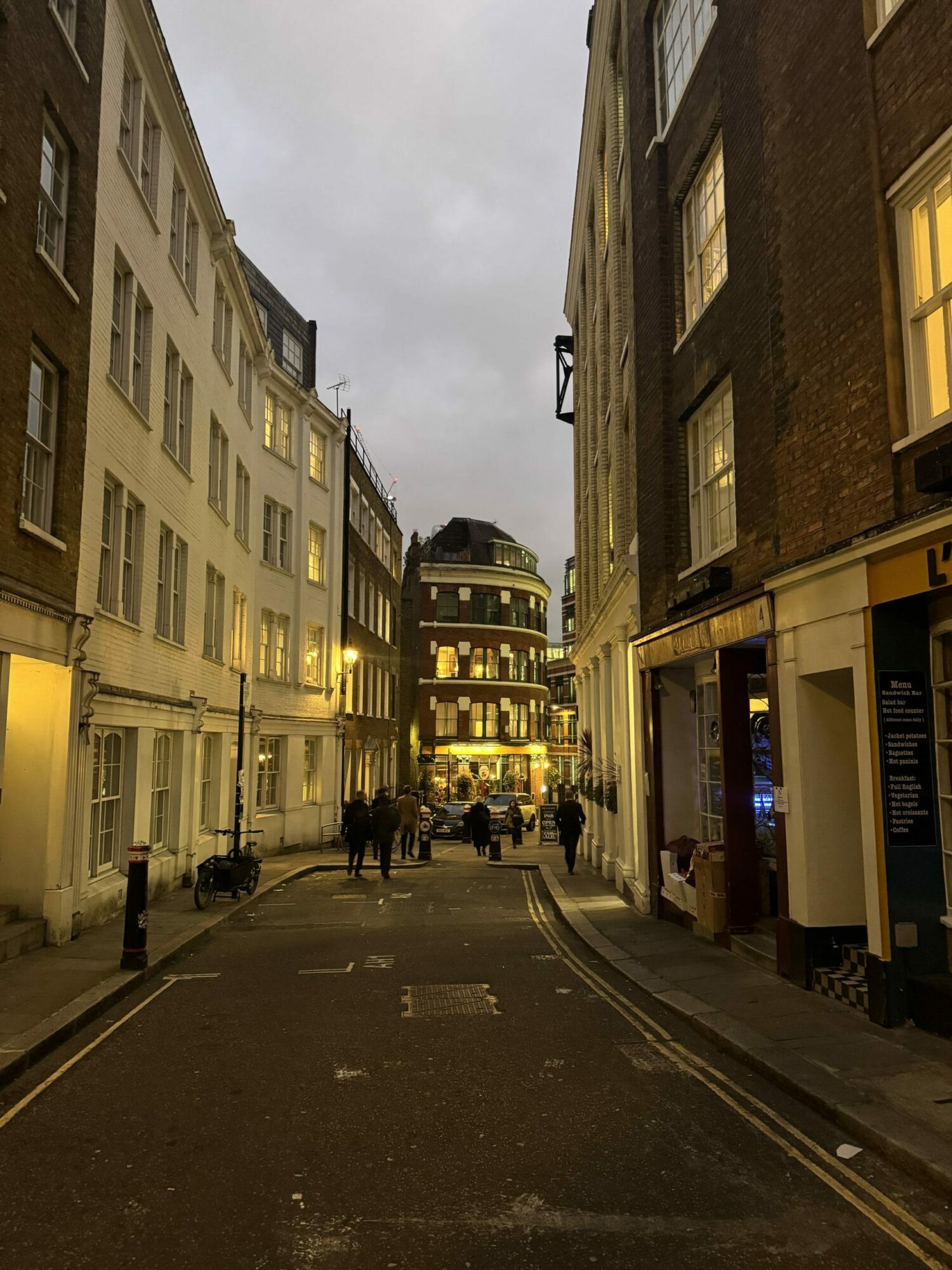 An image of a dark lane in the City with the Cockpit pub at the end