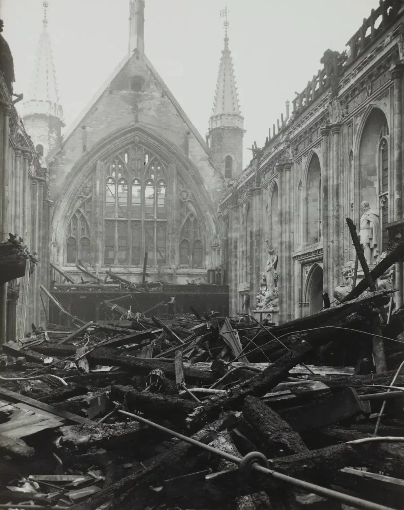 Black and white historical photo depicting the aftermath of significant damage to the Guildhall in the City of London, showing debris and collapsed structures.
