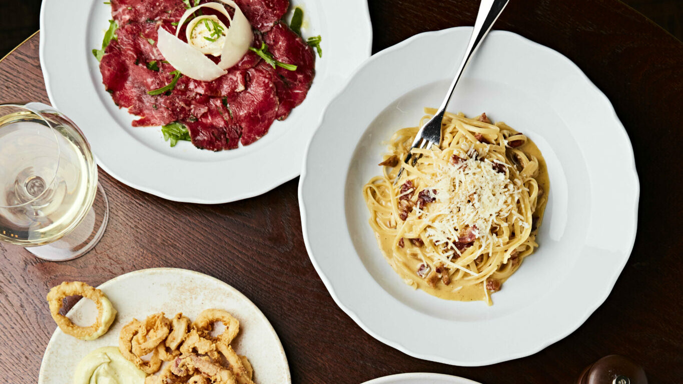 A dinner table full of plates, ready for a feast