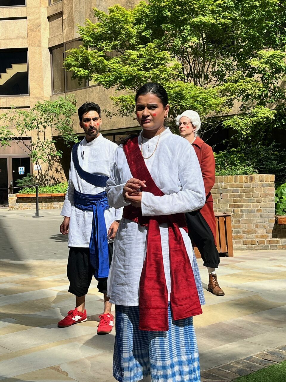 A group of actors performing a street play