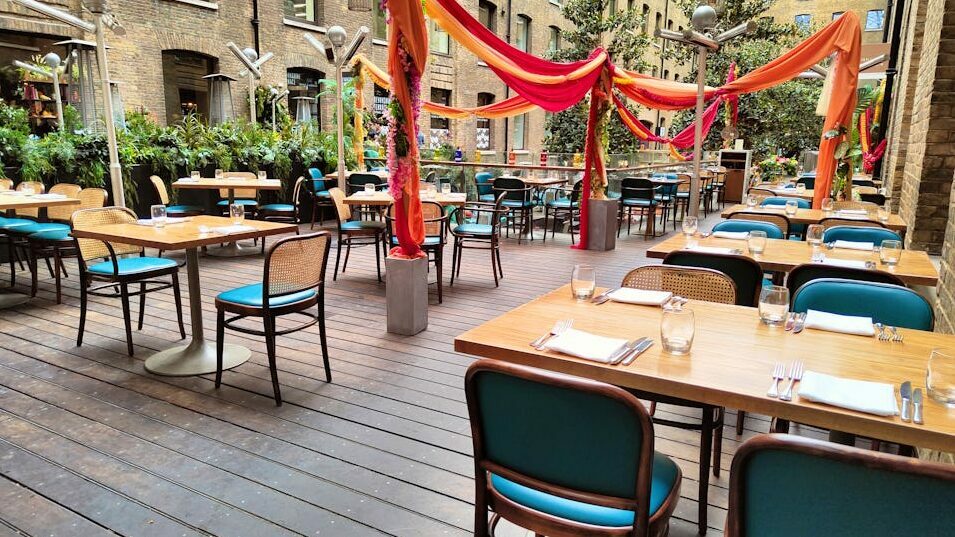 Photo taken from on Devonshire Terrace with empty tables at Cinnamon Kitchen
