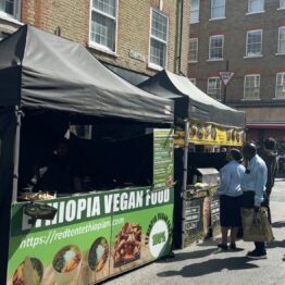 A food stall at the centre reading 'Ethiopian Vegan'